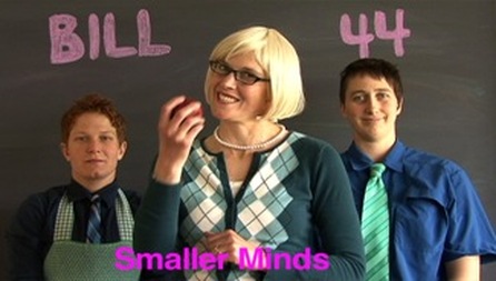Video still of TL Cowan, Danielle Peers & anon with captions: smaller minds, and sign: 